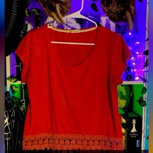 Pinkish red tea shirt with lace at the bottom